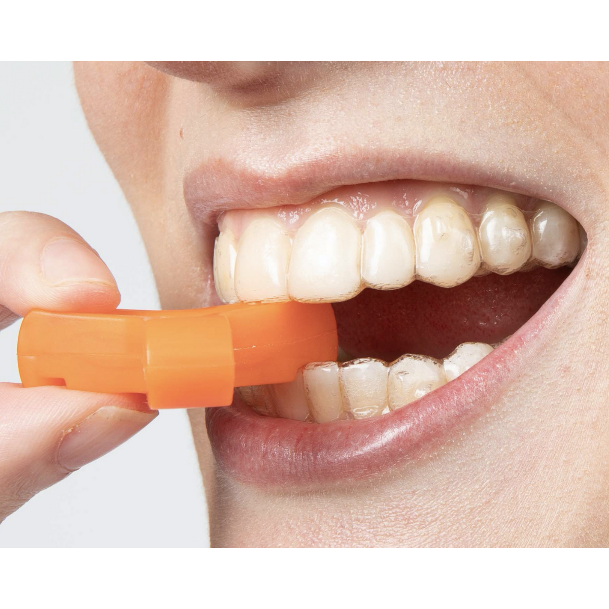 Orange Munchie engaged with bottom teeth